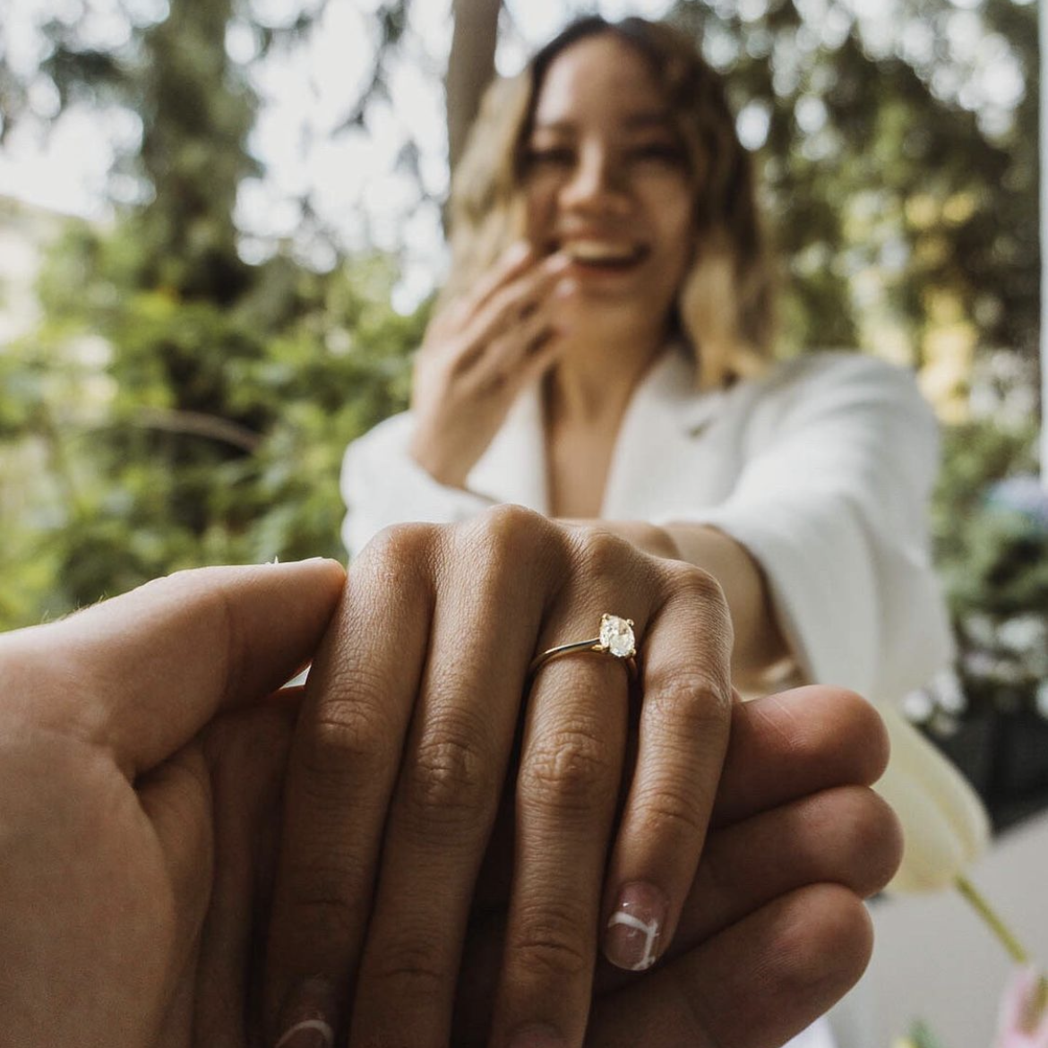 Photo of A unique engagement ring photo idea for couples