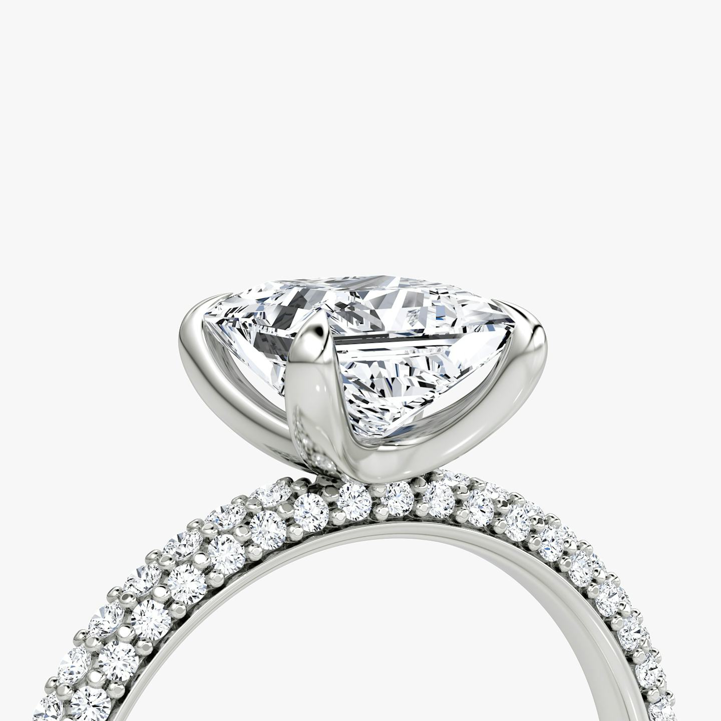 detail of three-row dome engagement ring princess cut in pave white gold