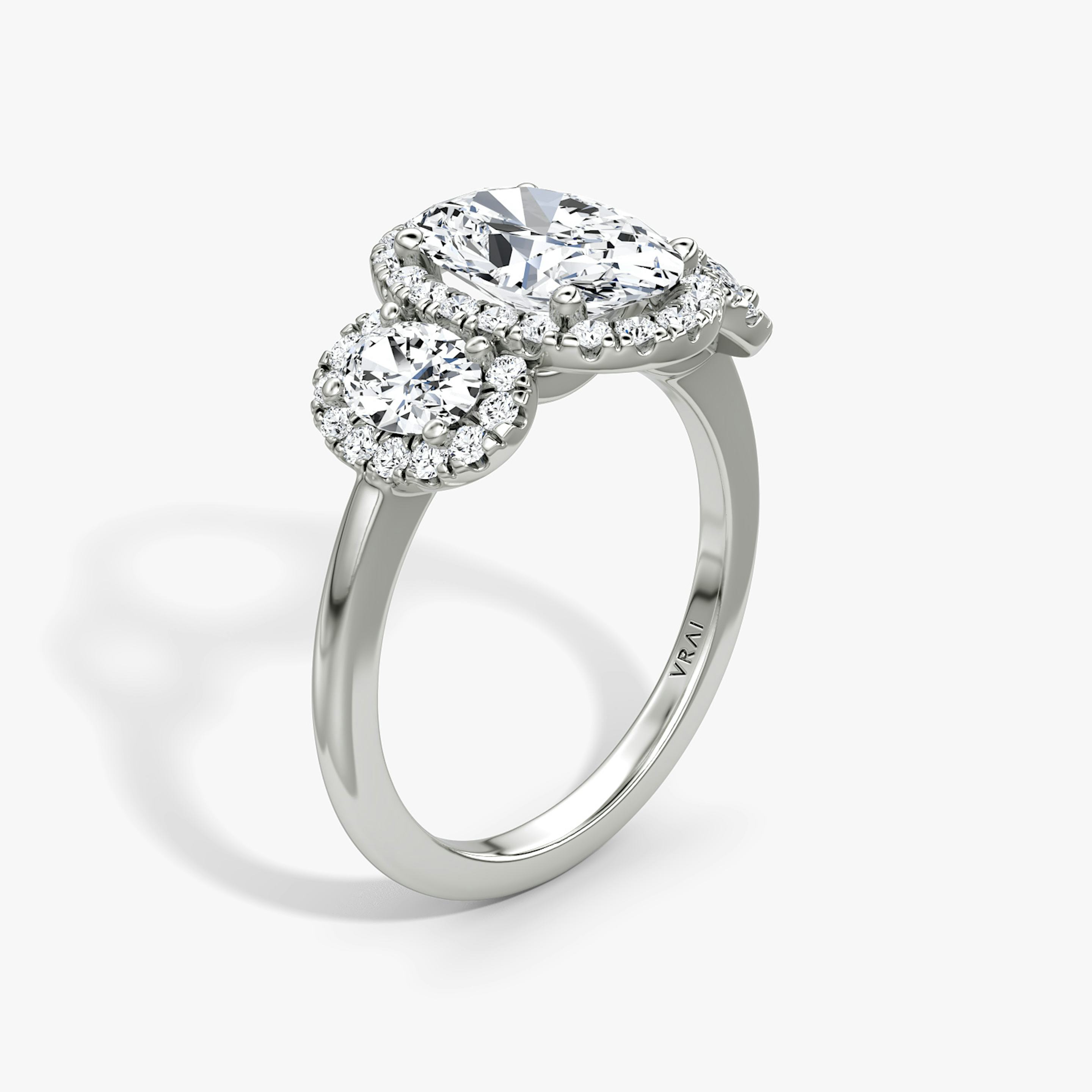 The Three Stone Halo | Oval | Platinum | Side stone carat: 1/4 | Diamond orientation: vertical | Carat weight: See full inventory