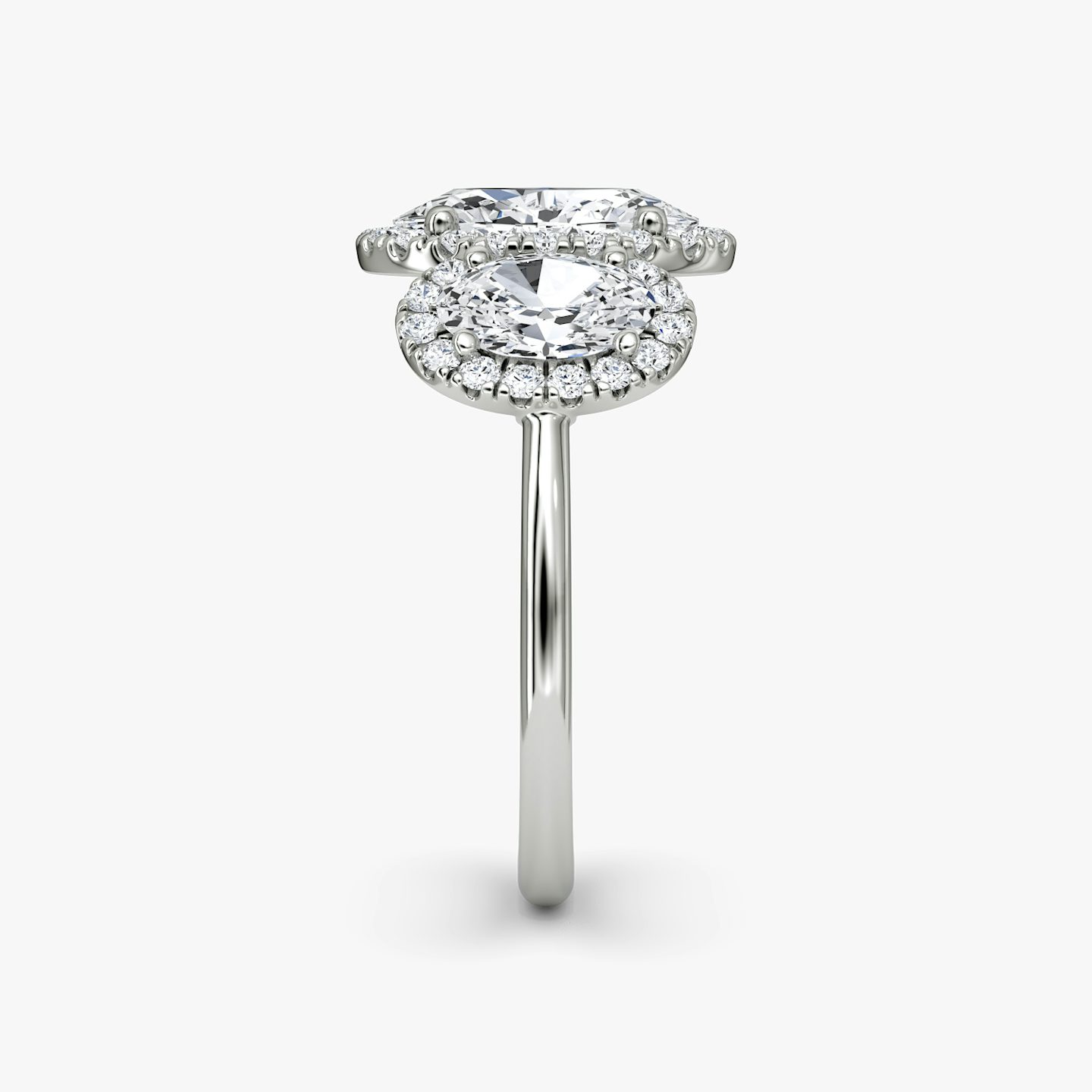 The Three Stone Halo | Oval | Platinum | Band: Plain | Side stone carat: 1/2 | Diamond orientation: vertical | Carat weight: See full inventory