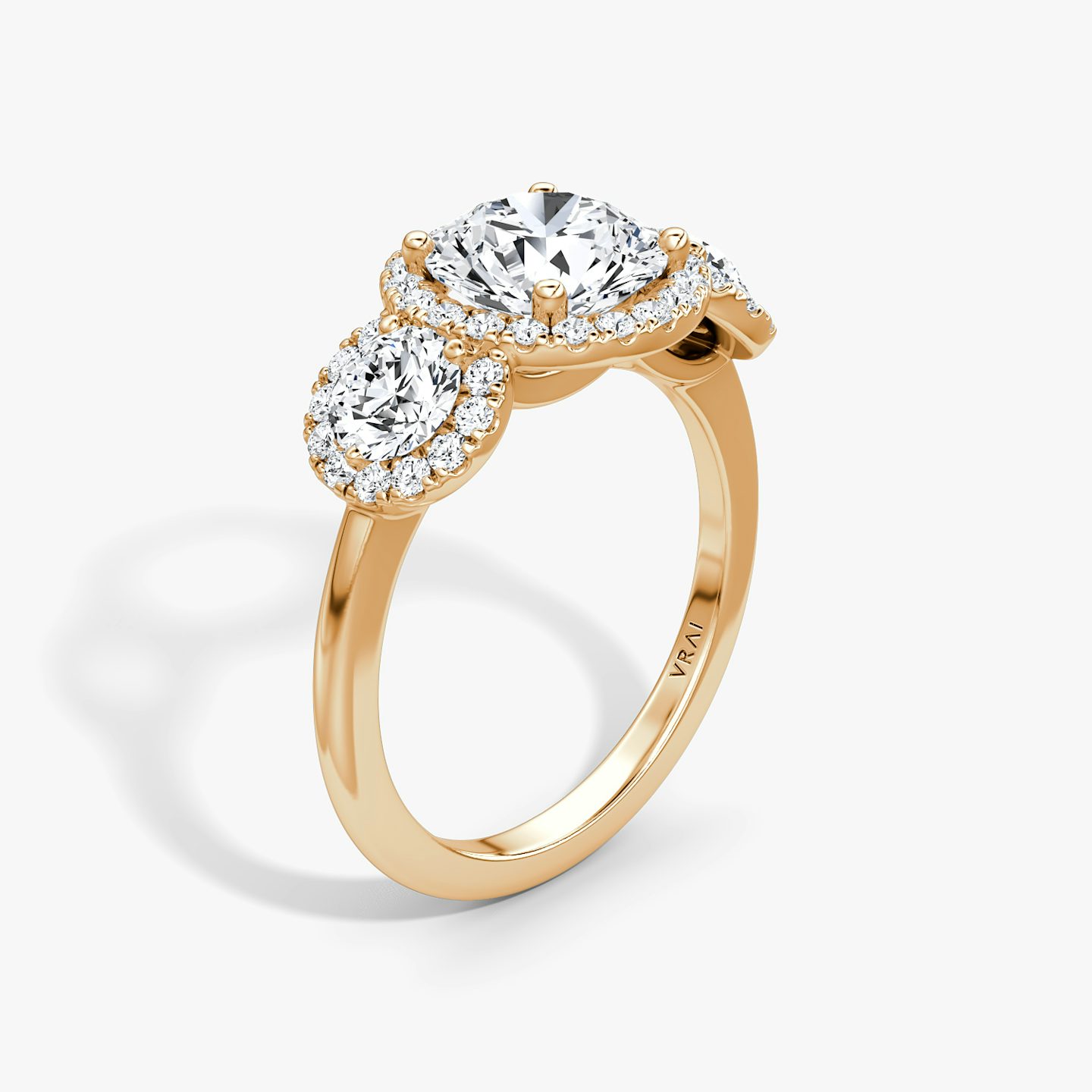 The Three Stone Halo | Round Brilliant | 14k | 14k Rose Gold | Carat weight: See full inventory | Side stone carat: 1/4 | Diamond orientation: vertical
