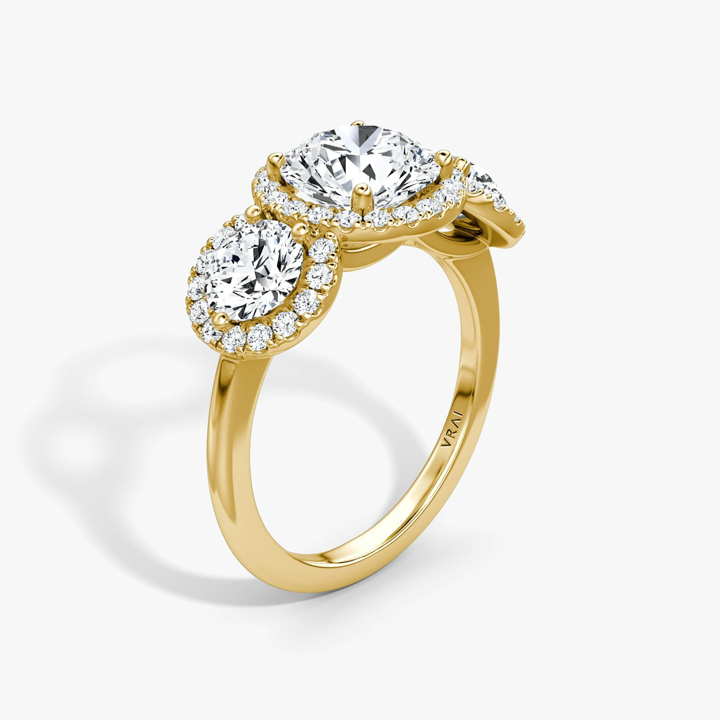 The Three Stone Halo | Round Brilliant | 18k | 18k Yellow Gold | Carat weight: See full inventory | Side stone carat: 1/2 | Diamond orientation: vertical