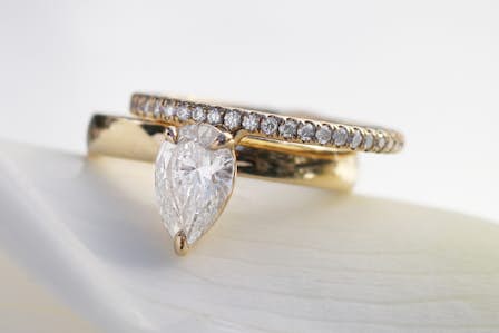 pear shaped engagement ring and wedding band in yellow gold