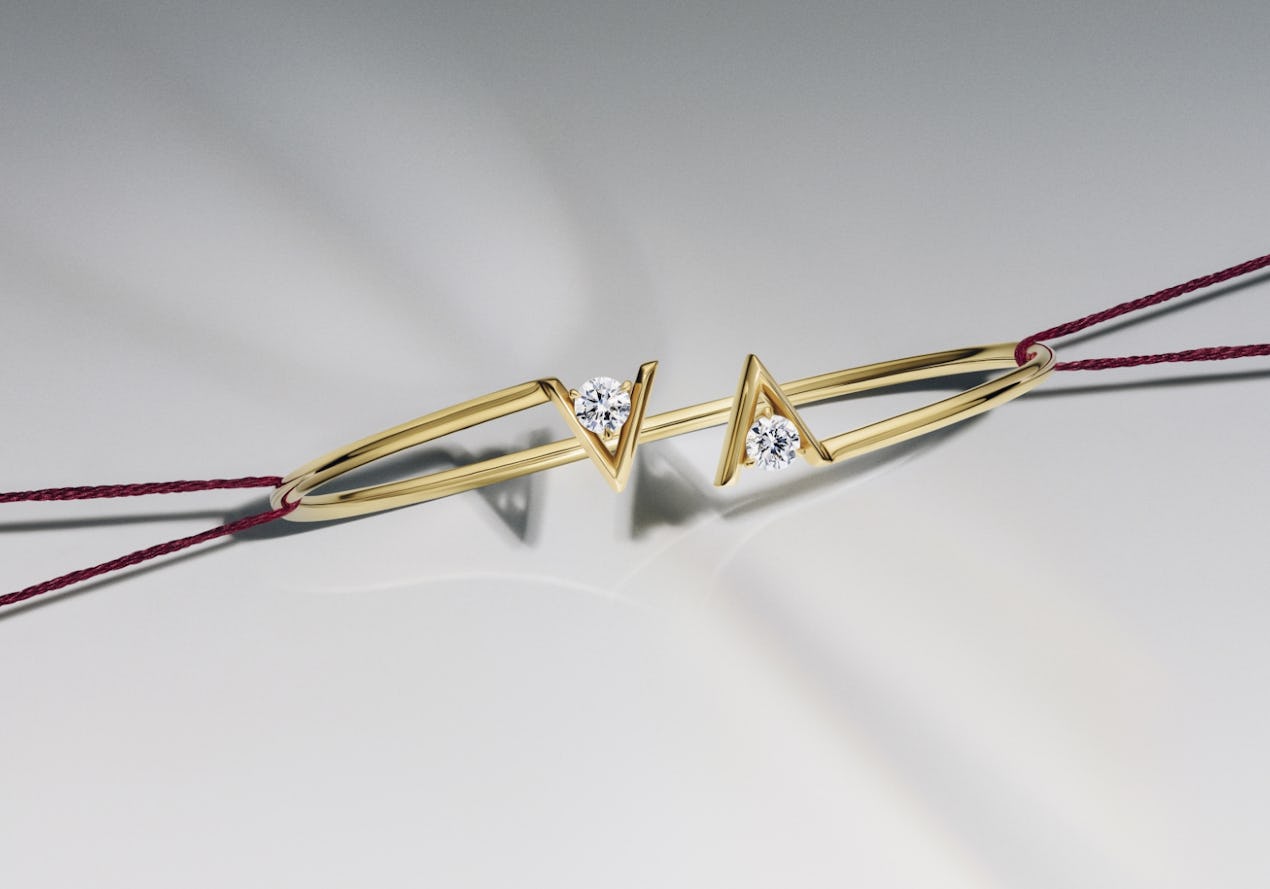 gold bracelet with two v shaped designs surrounding the lab grown diamonds
