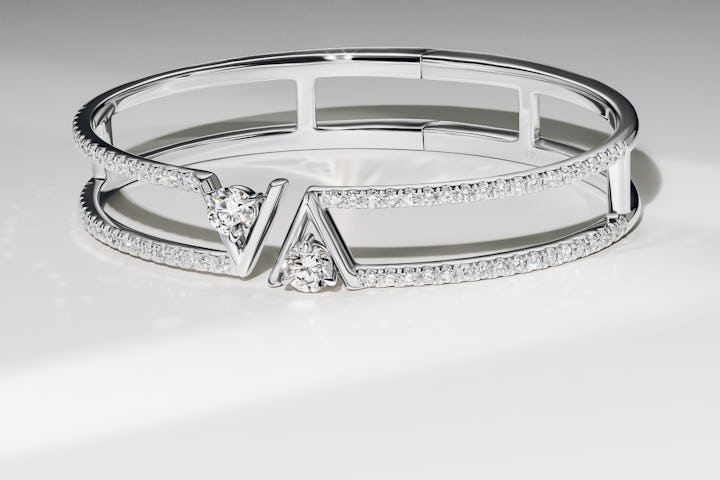 two row bangle bracelet in white gold with a v shape design surrounding lab created diamonds