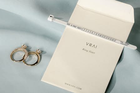 vrai ring sizer with two rings next to packaging
