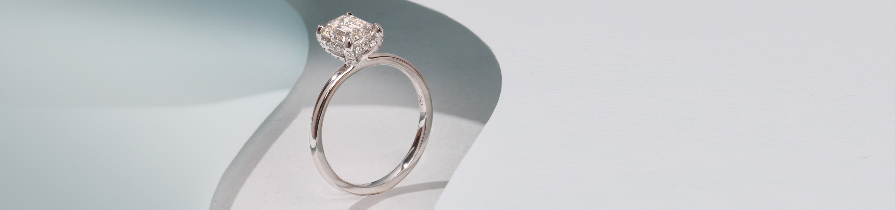 Solitaire engagement ring in platinum with a emerald cut lab grown diamond