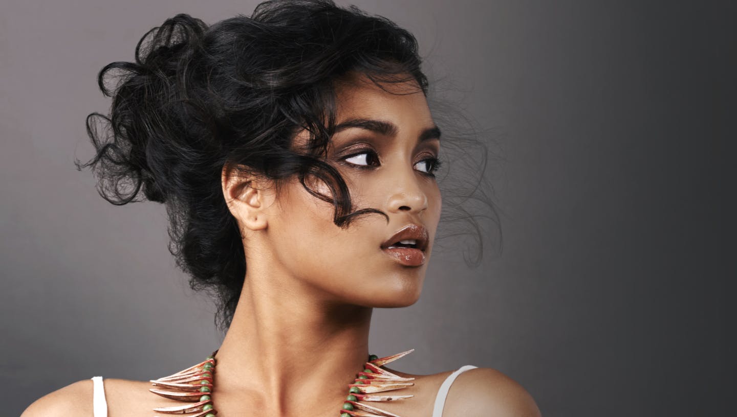 Beautiful woman with curly black hair in an updo