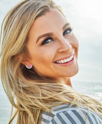 Blonde woman looking back over her shoulder smiling