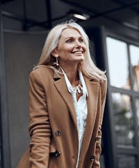 Beautiful middle aged woman smiling outside