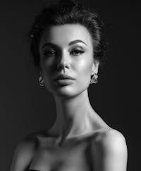 Elegant woman with a serious facial expression and bare shoulders