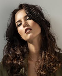 Woman with long curly brown hair