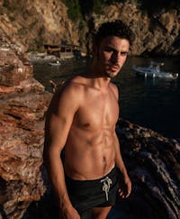 Handsome man outside shirtless with defined abs