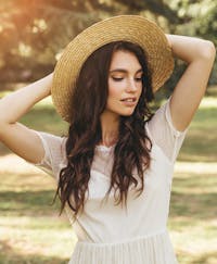 Woman outside wearing a straw hat
