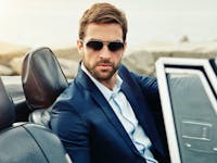 Handsome man in a car wearing sunglasses