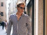 Blonde man outside wearing a striped shirt and sunglasses