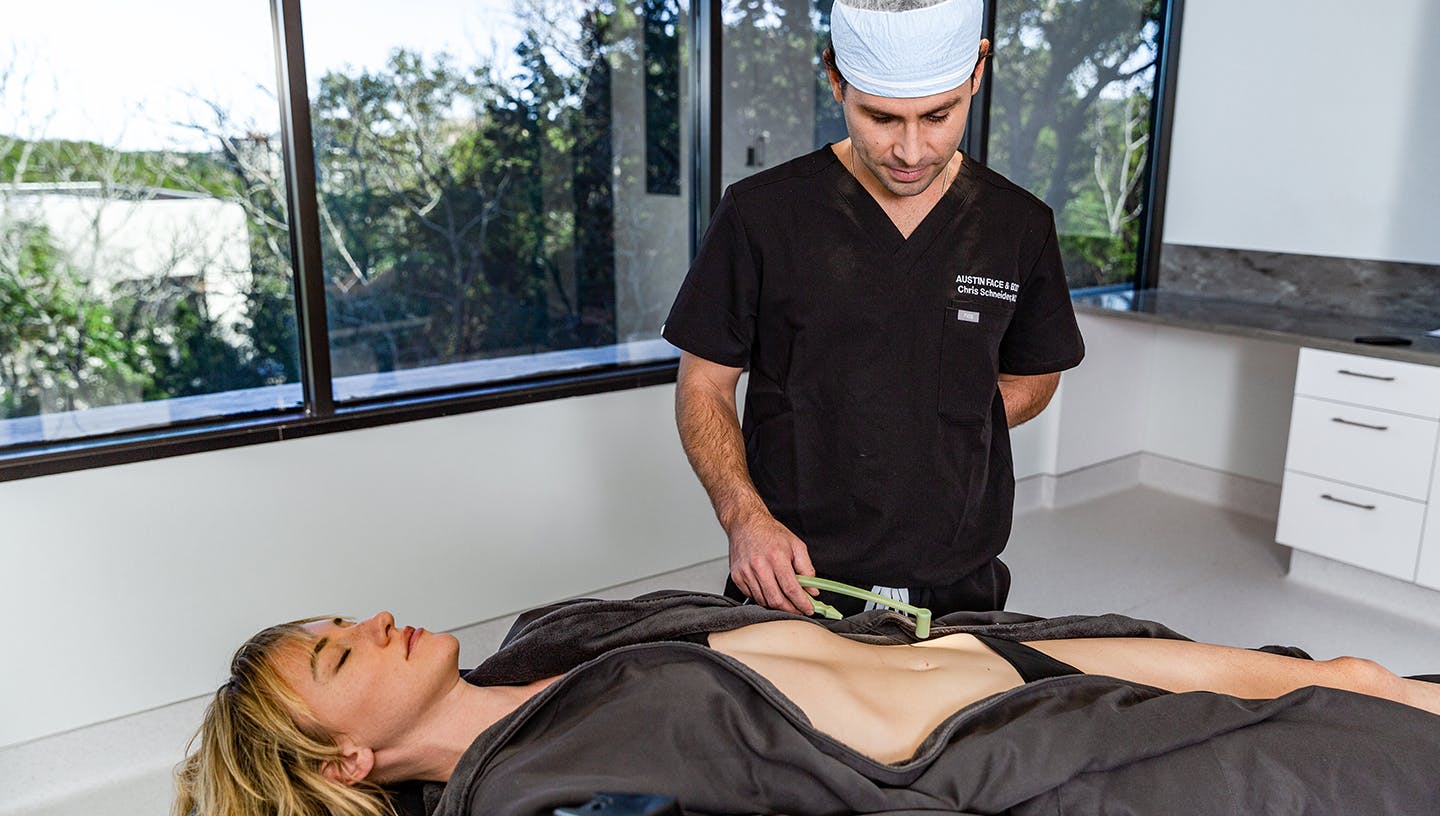 Female patient undergoing consultation for tummy tuck surgery at Austin Face & Body