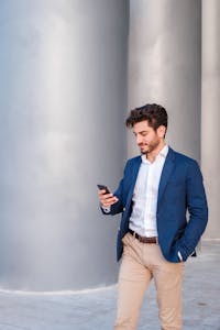 A man in a suit looking at his phone