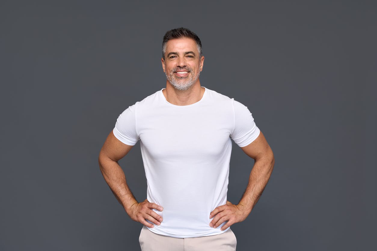 A man in white shirt holding his hands on his hips