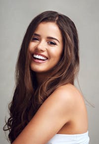 A brunette woman smiling at camera