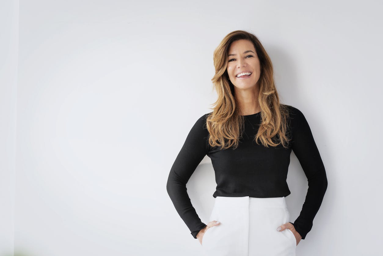 A woman in a black shirt smiling