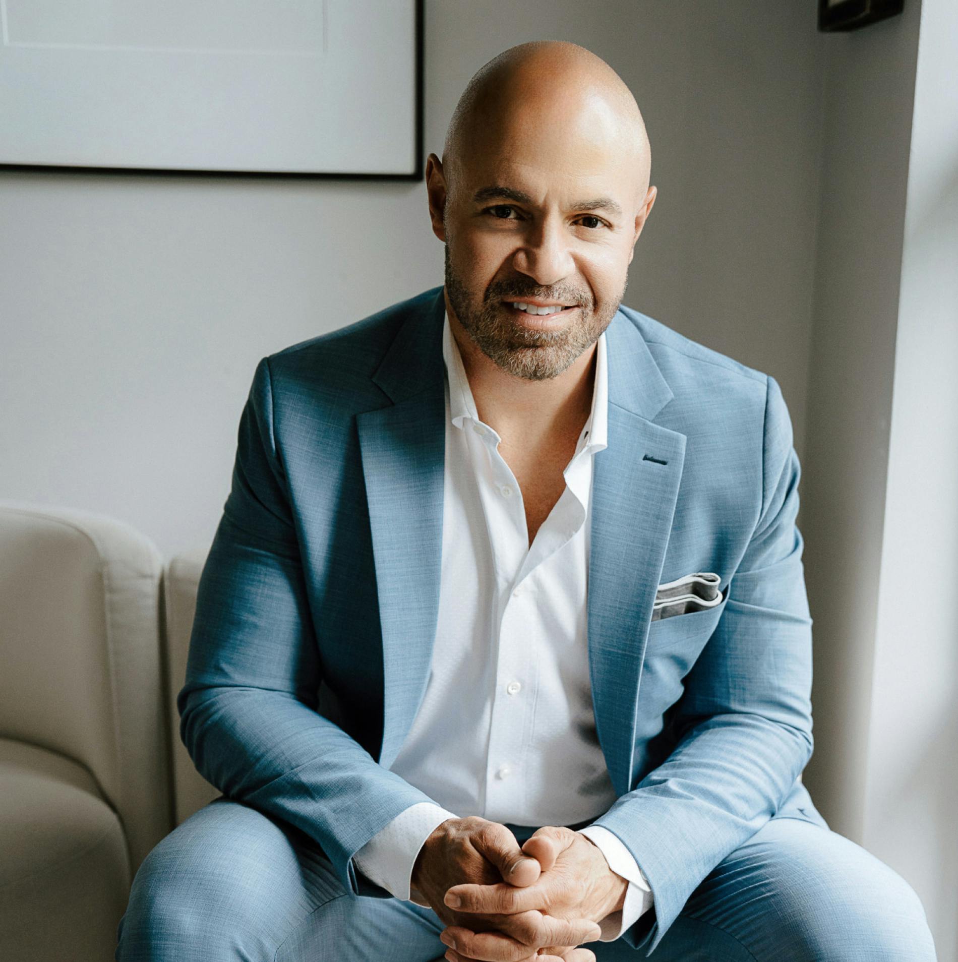 Dr. Pratt sitting in a blue suit and smiling