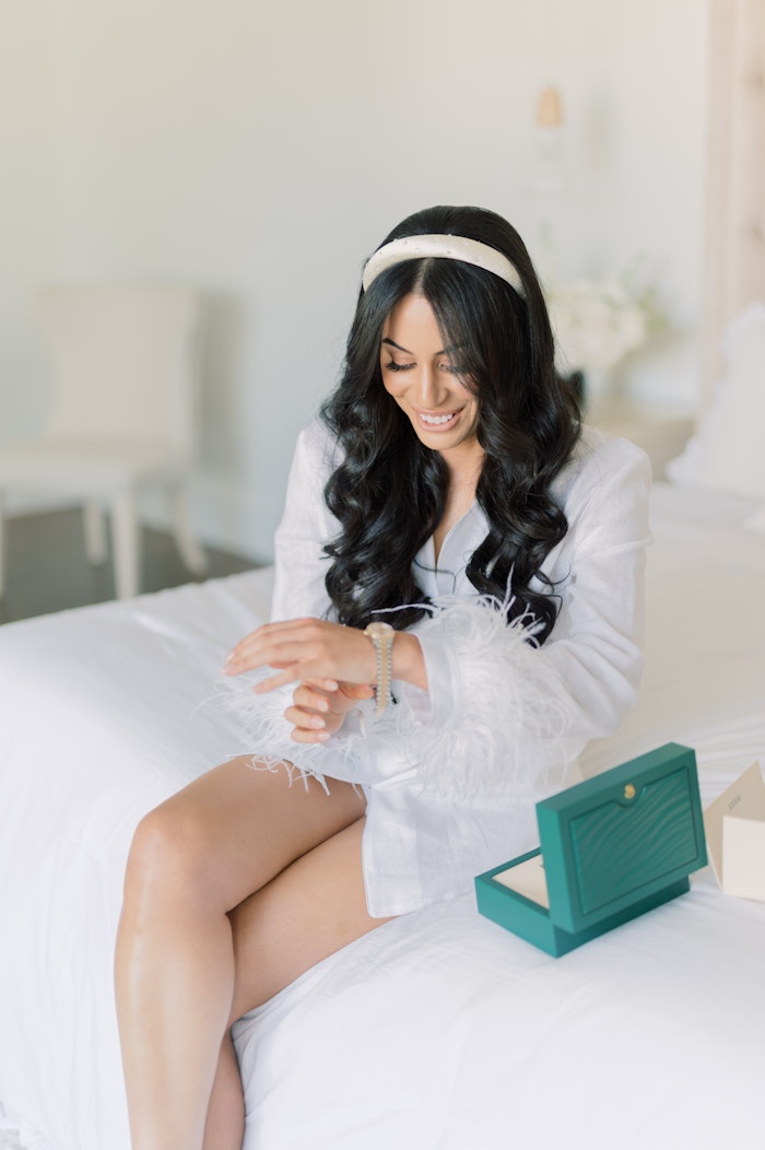 The bride opened a gift from her groom, a Rolex watch.