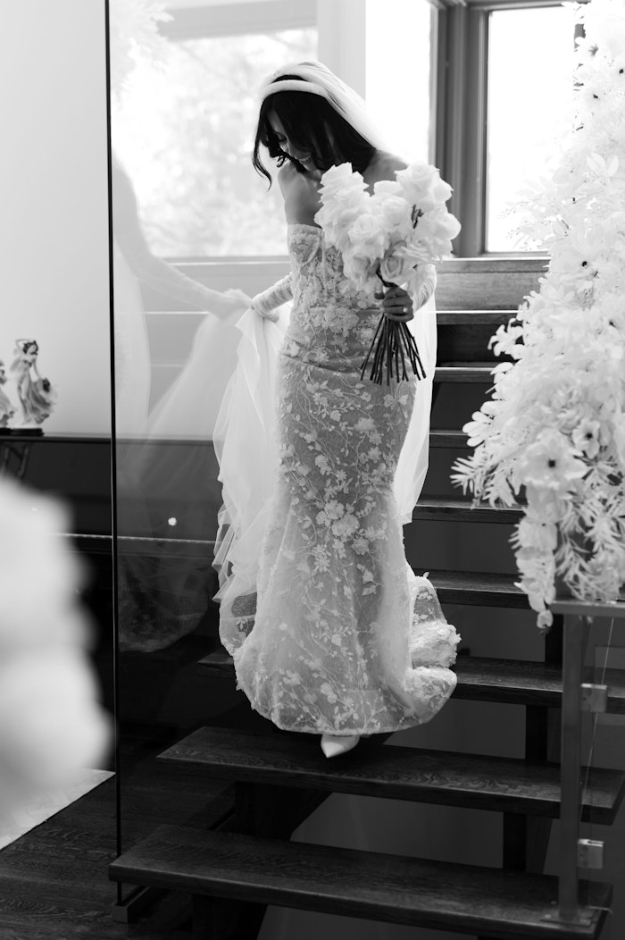 Authentic film photography by the best wedding photographer in Toronto showcases the bride coming down the stairs.