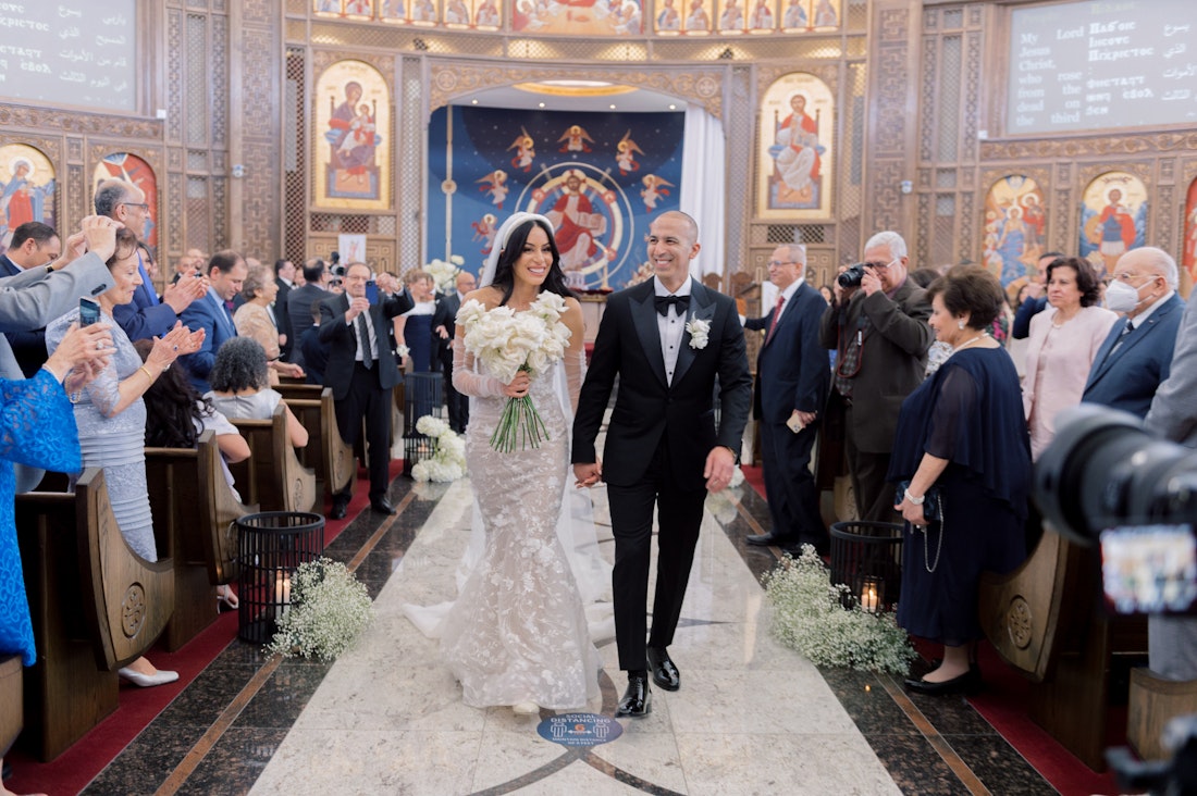 Photographed by top photographer Whitney Heard, featuring the bride and groom walking down the isl celebrating the moment right after they say their wedding vows.