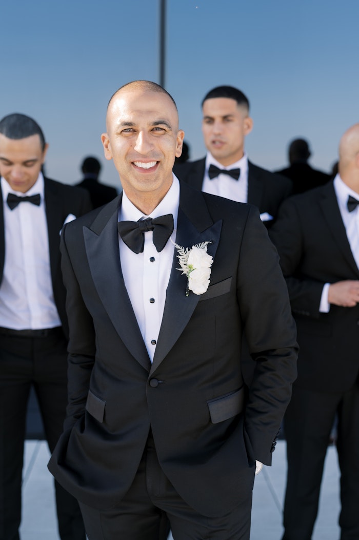 A modern wedding at the Globe and Mail Toronto, showcasing the groom with a classic black tuxedo.