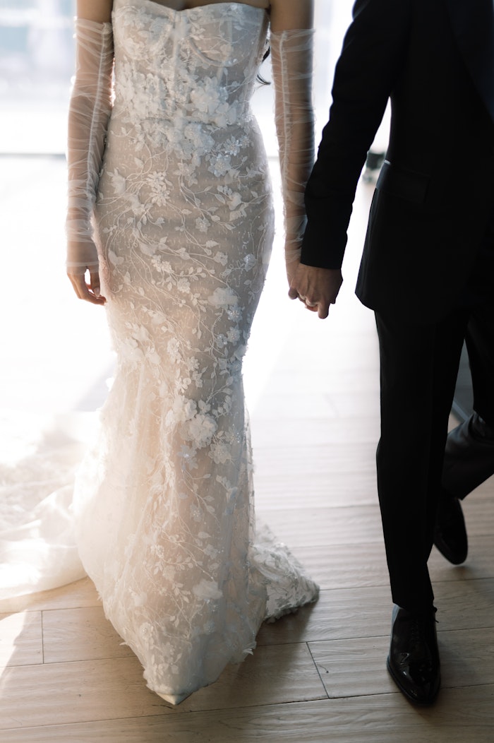 Cinematic bride and groom portrait showing the details of the wedding dress in downtown Toronto