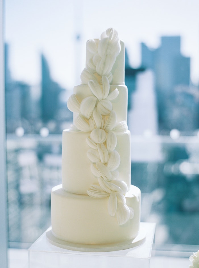Romantic wedding cake with soft feminine details with the toronto skyline at the globe and mail