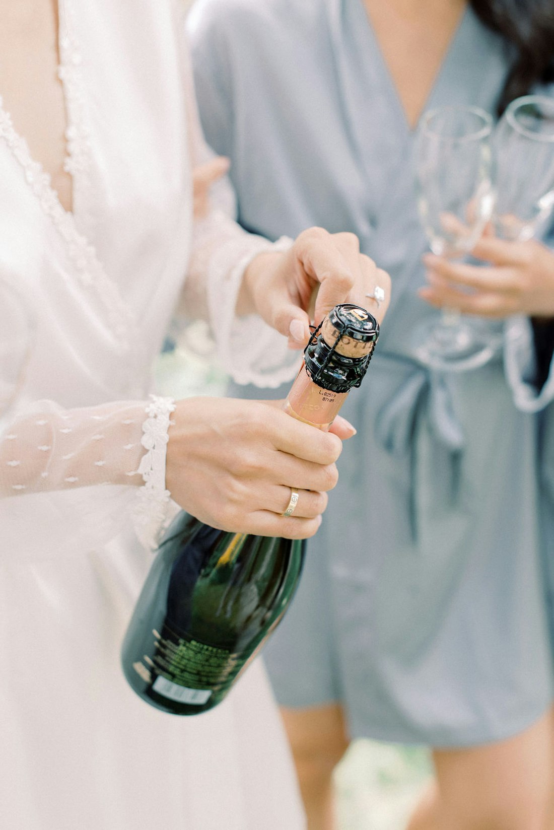 Bride popping bottle in natural window light at Spadina House Museum Toronto wedding morning