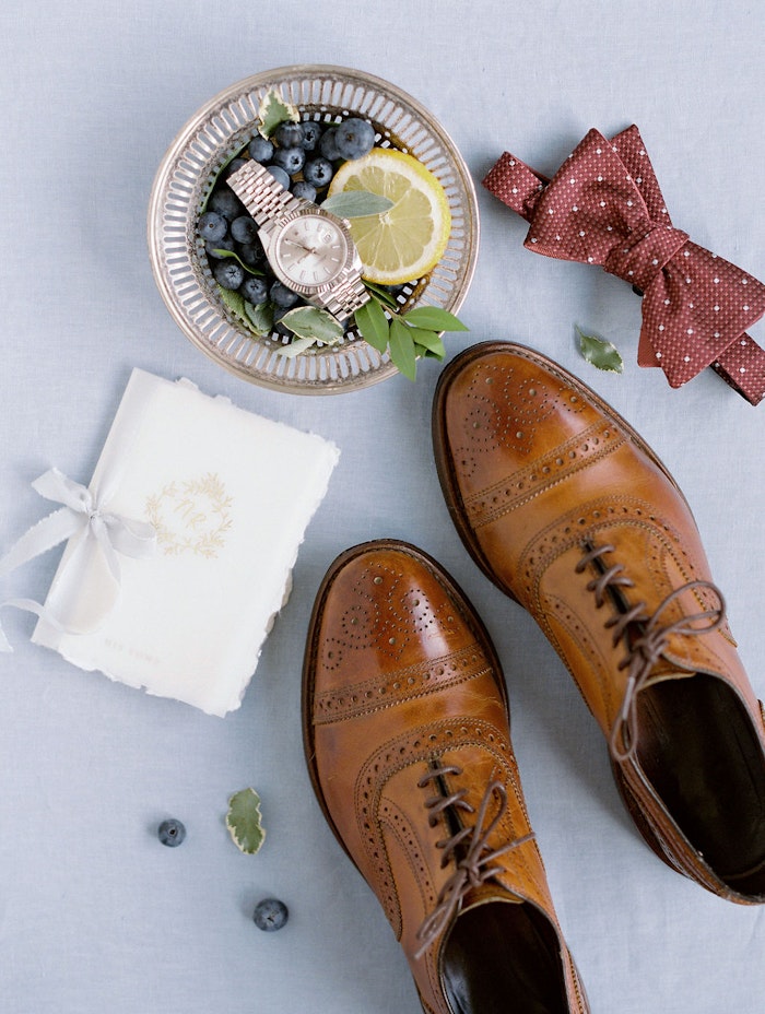 Toronto wedding photographer capturing soft blue wedding stationery flat lay with vow books and ribbons at Spadina House Museum