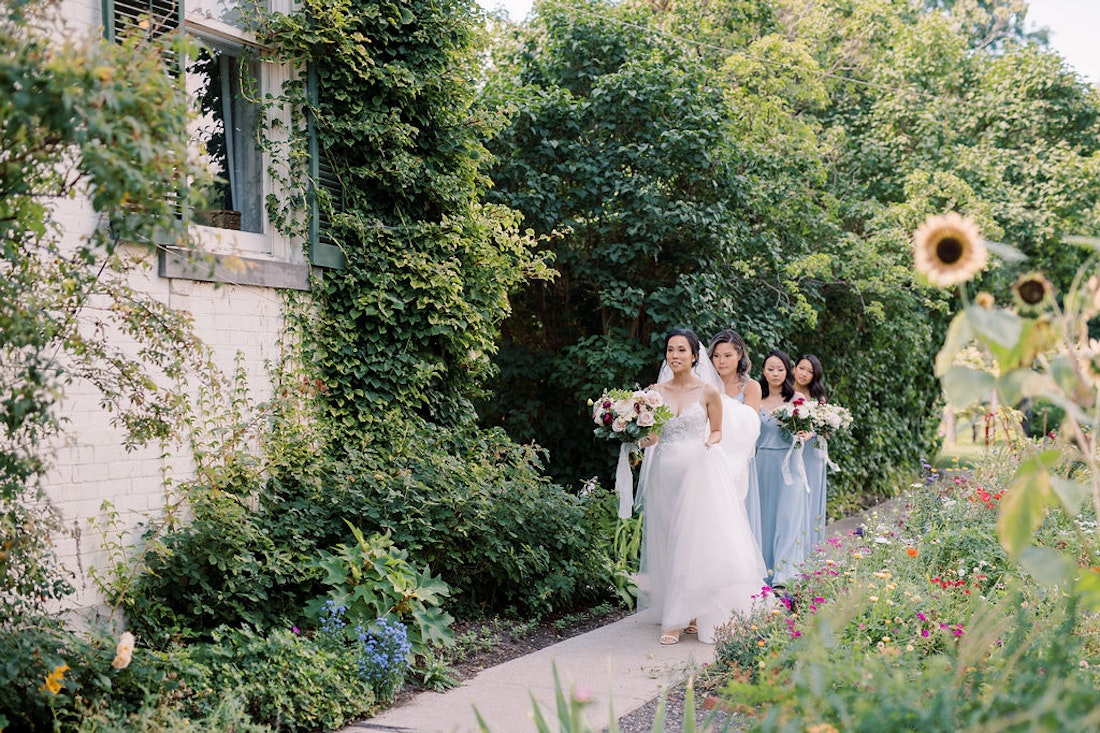 Bridesmaids helping bride with dress at Spadina House Museum.