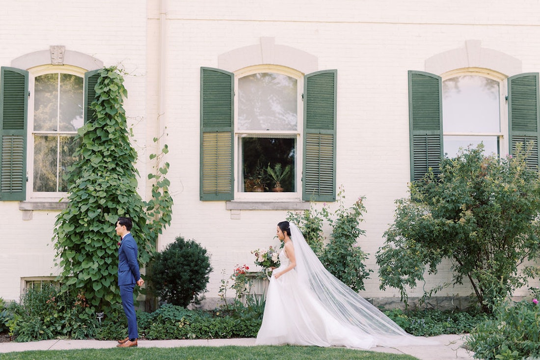 Emotional first look between bride and groom at Spadina House Museum Toronto garden wedding