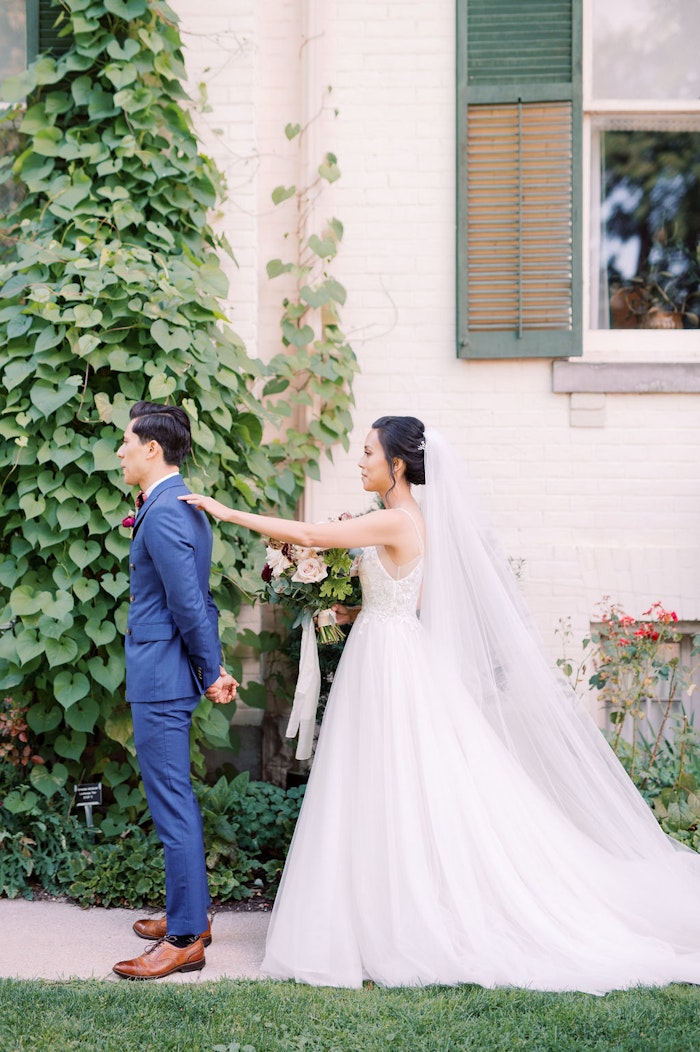 Emotional first look between bride and groom at Spadina House Museum Toronto garden wedding
