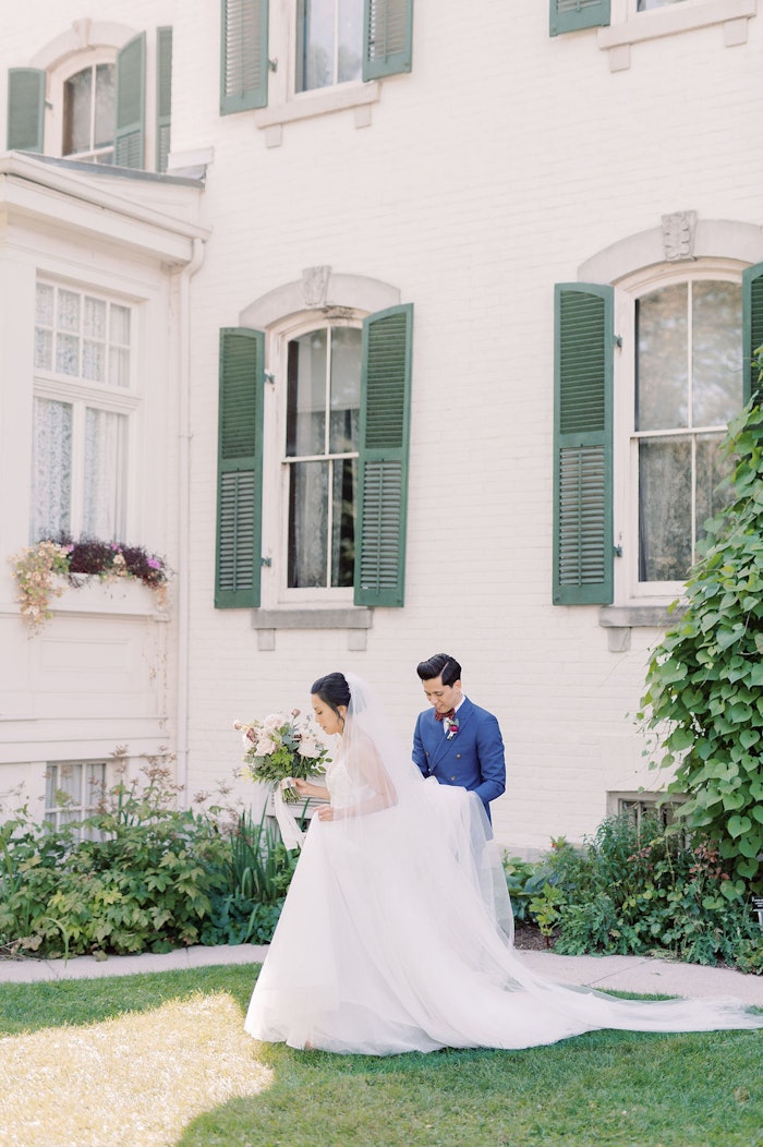 Outdoor wedding ceremony at Spadina House Museum Toronto with guests seated in garden setting