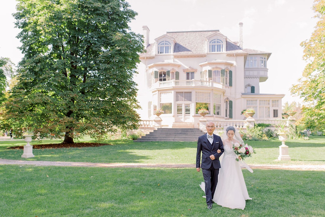 Bride walking down the aisle at Spadina House garden wedding ceremony in Toronto