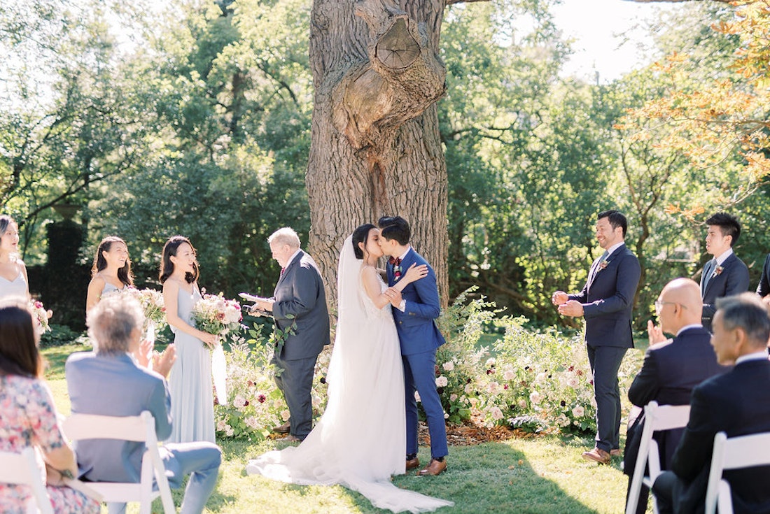 Bride walking down the aisle at Spadina House garden wedding ceremony in Toronto