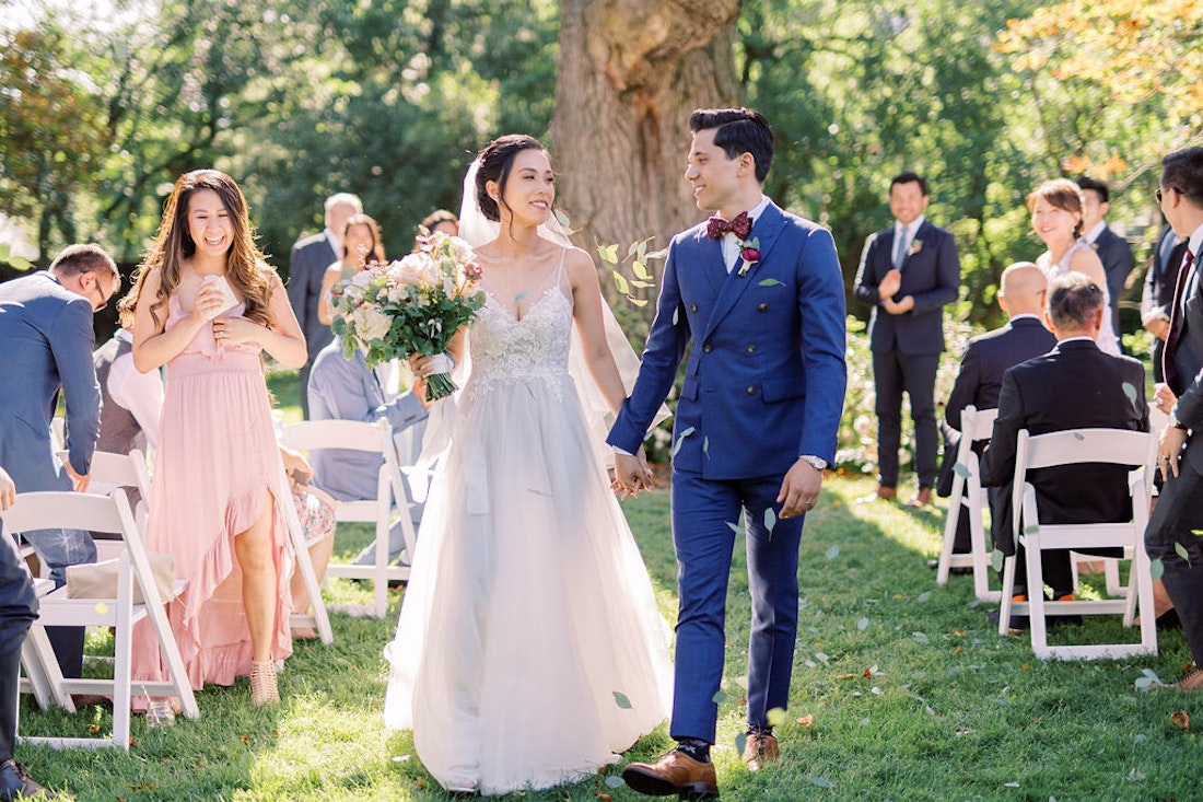 Outdoor wedding ceremony at Spadina House Museum Toronto with guests seated in garden setting