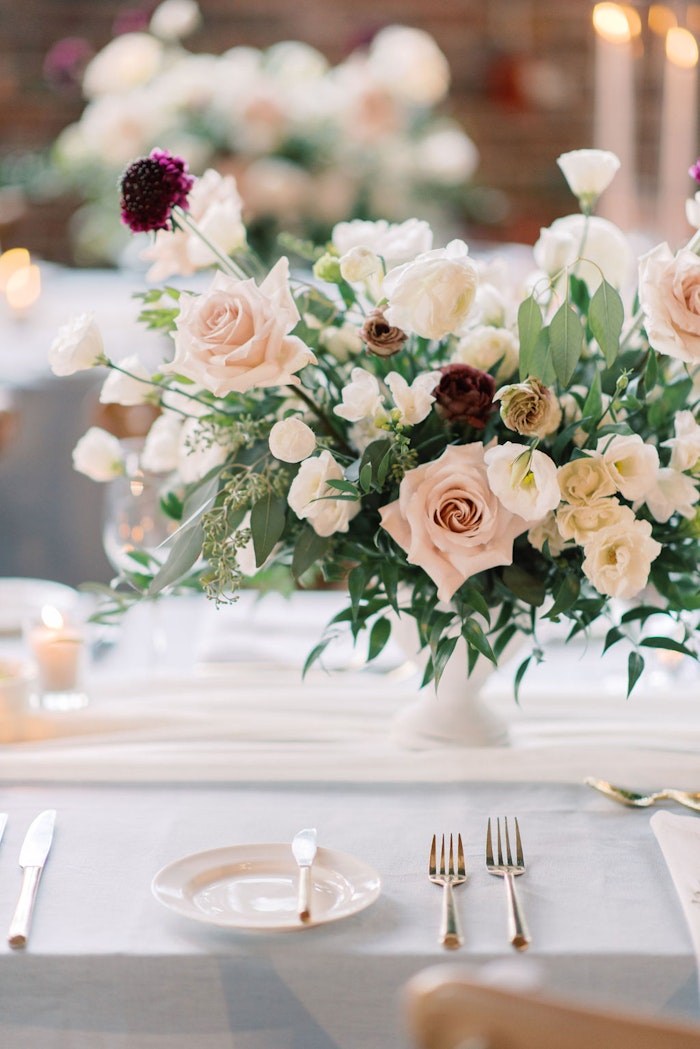 Elegant wedding reception at Steam Whistle Roundhouse Toronto with floral design and candlelight