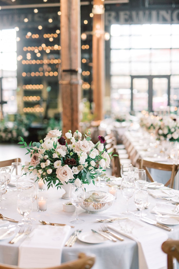 Elegant wedding reception at Steam Whistle Roundhouse Toronto with floral design and candlelight