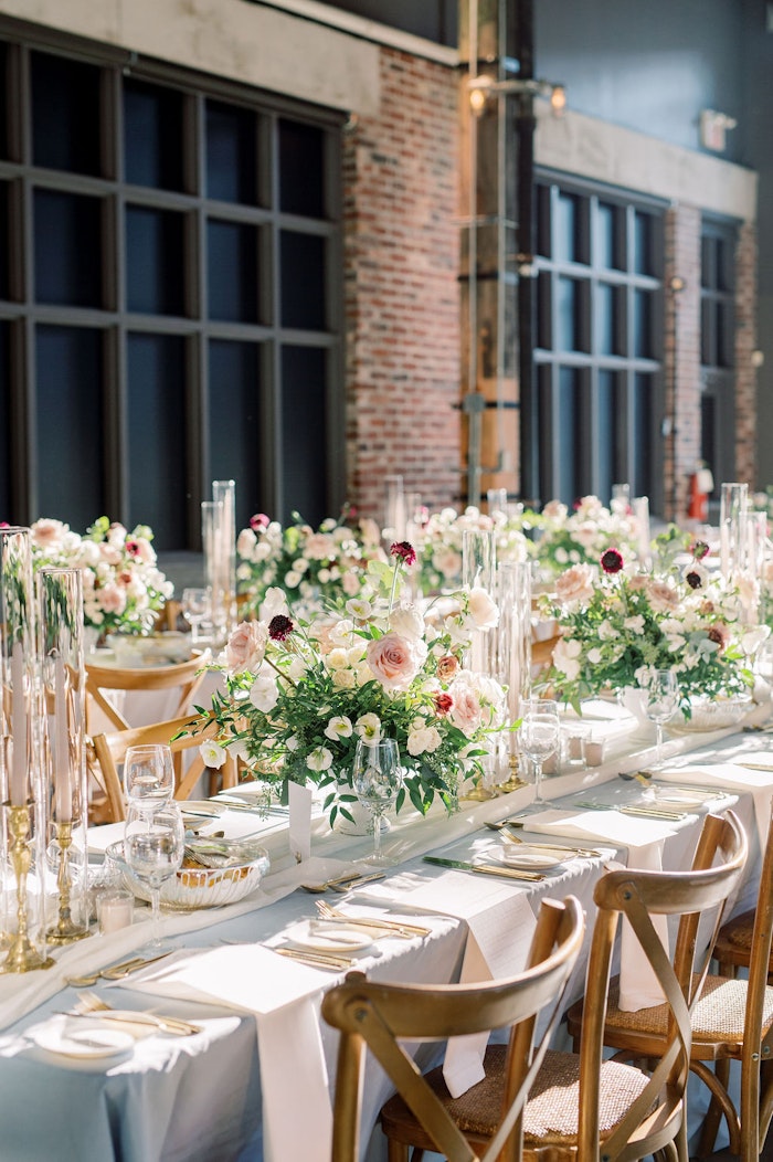 Elegant wedding reception at Steam Whistle Roundhouse Toronto with floral design and candlelight