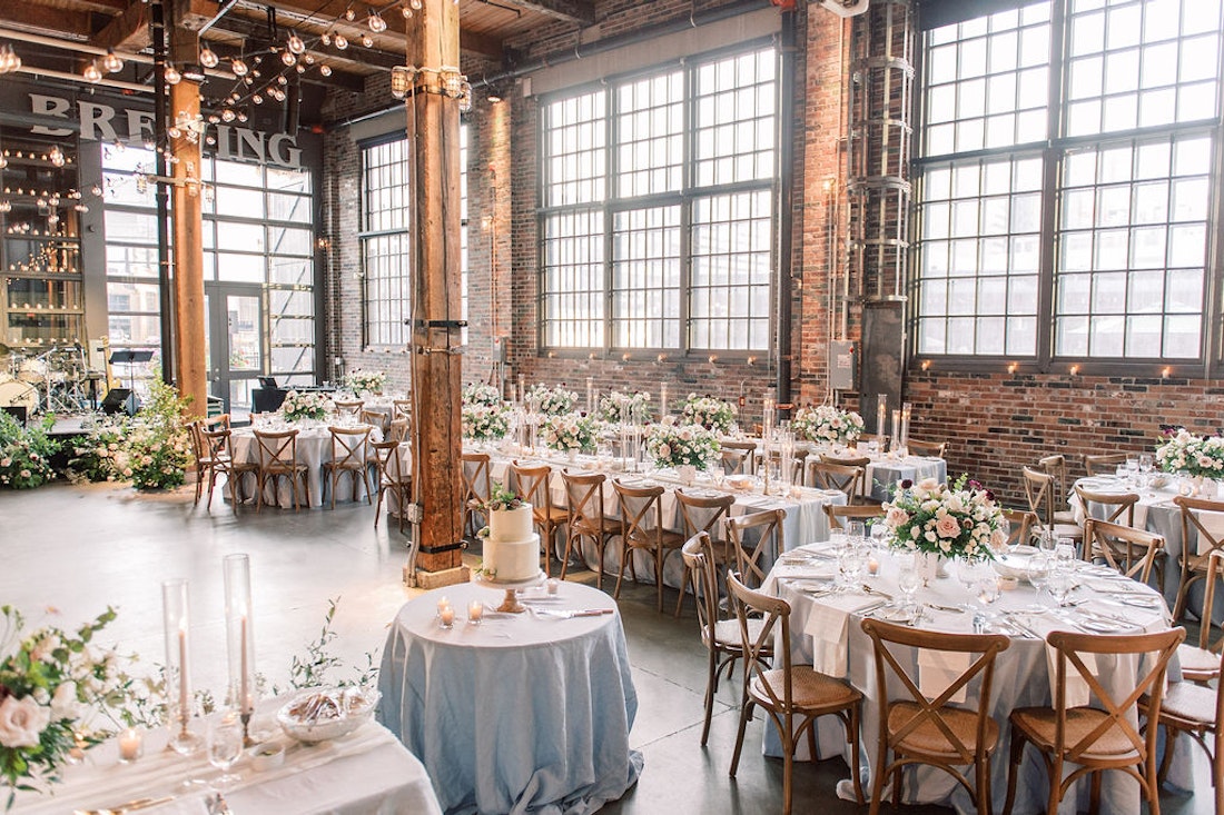 Elegant wedding reception at Steam Whistle Roundhouse Toronto with floral design and candlelight