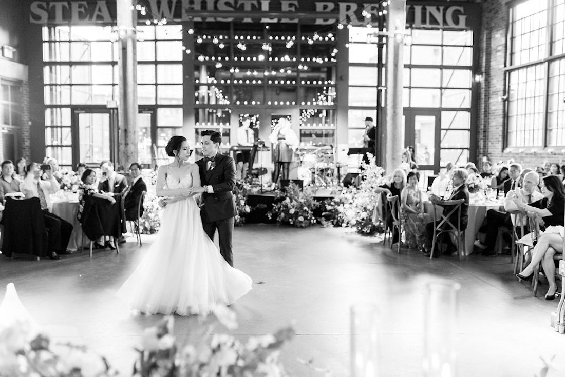 Elegant wedding reception at Steam Whistle Roundhouse Toronto with floral design and candlelight