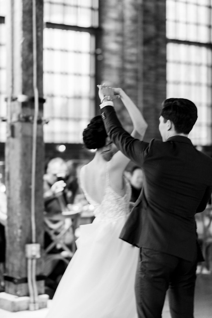 Motion blur in a black and white image of a bride and groom during their first dance.