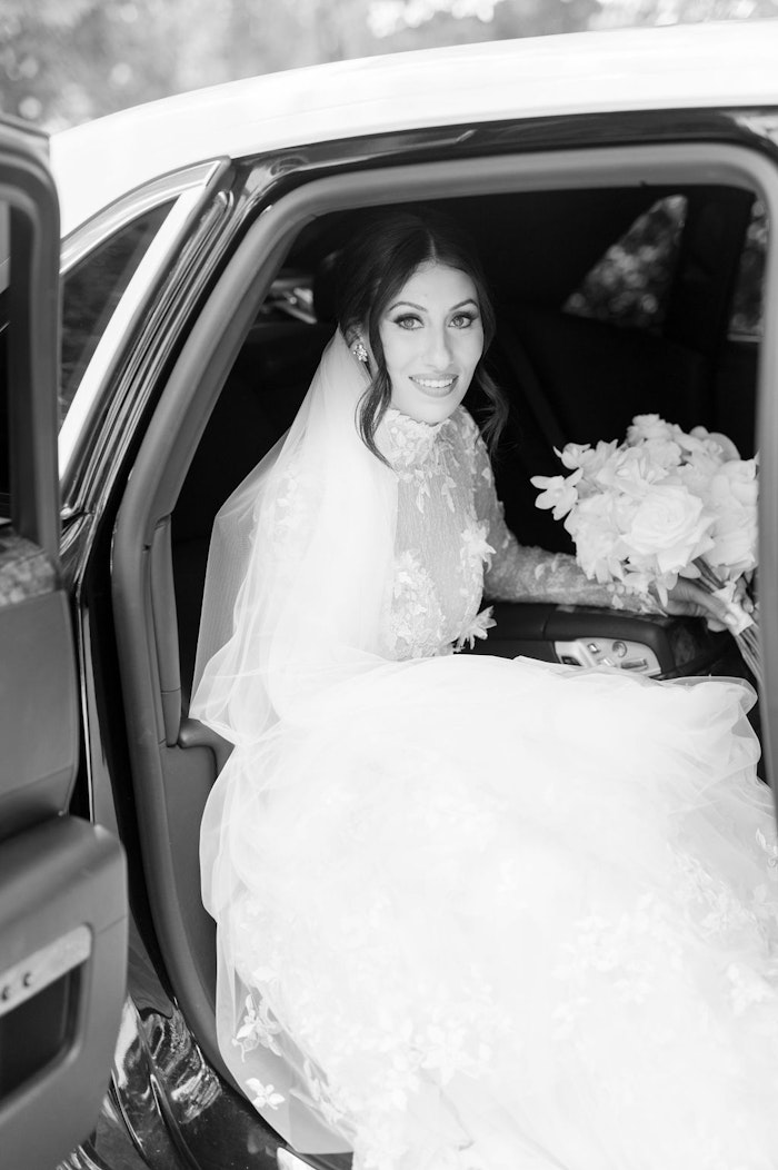 Bride posing with Rolls Royce luxury wedding car Toronto