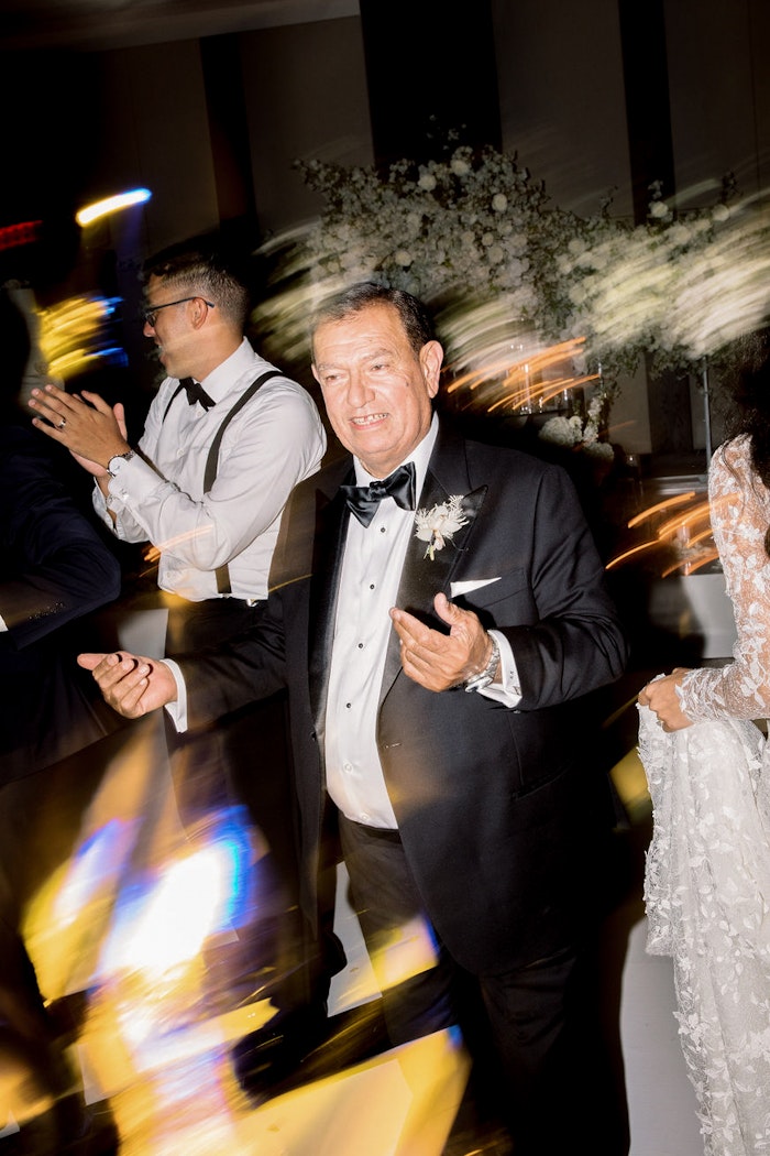 Fun candid wedding party moment inside reception