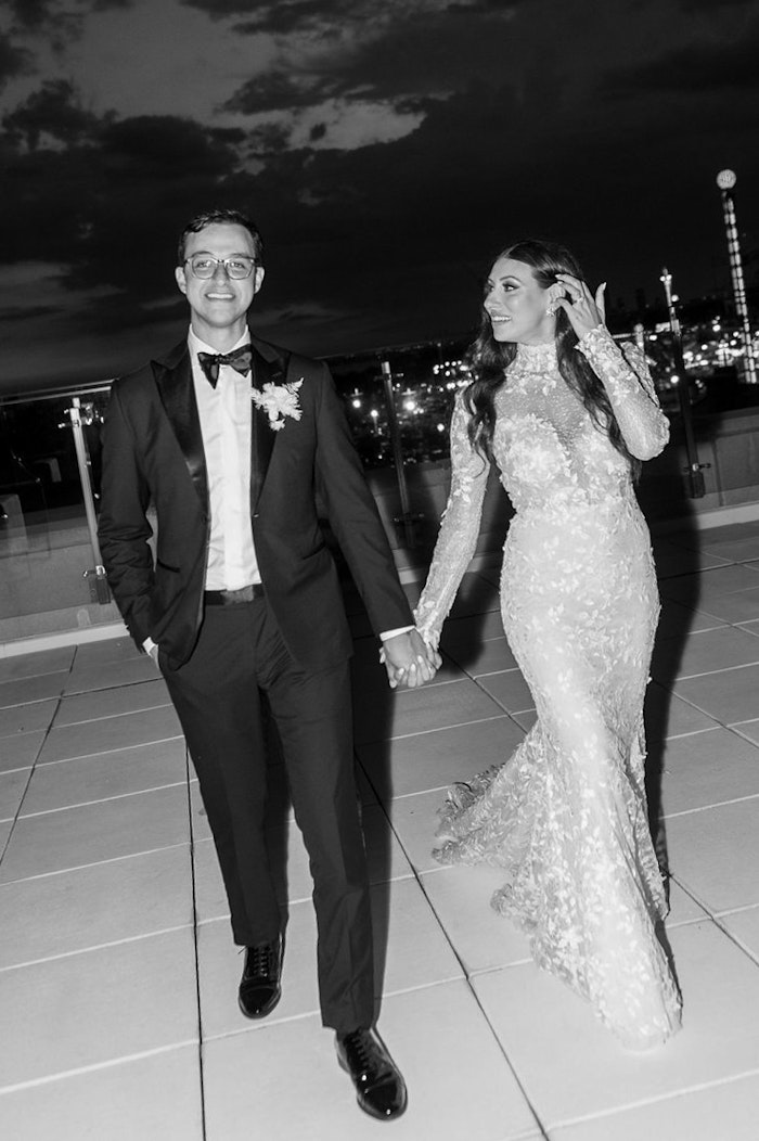 Elegant couple portrait with veil and architectural background